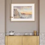 Stunning framed scene of Saint-Malo’s stormy coast with vibrant sunset colors and crashing waves.