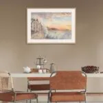Framed seascape of Saint-Malo’s stormy ocean, with waves captured in motion and a glowing sunset in the background.