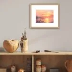 Framed ‘Golden Sunset’ painting on a wall, bringing a peaceful and vibrant atmosphere with its radiant sunset colors.