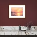 ‘Golden Sunset’ framed in a minimalist dining room, offering a calming ocean scene with rich sunset tones.