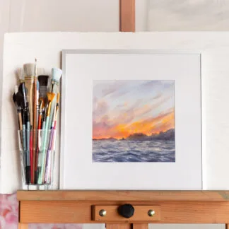 Framed watercolor painting 'Sunset by the Sea' – stormy deep blue ocean waves under a glowing sunset sky, expressive seascape wall art for coastal home decor.