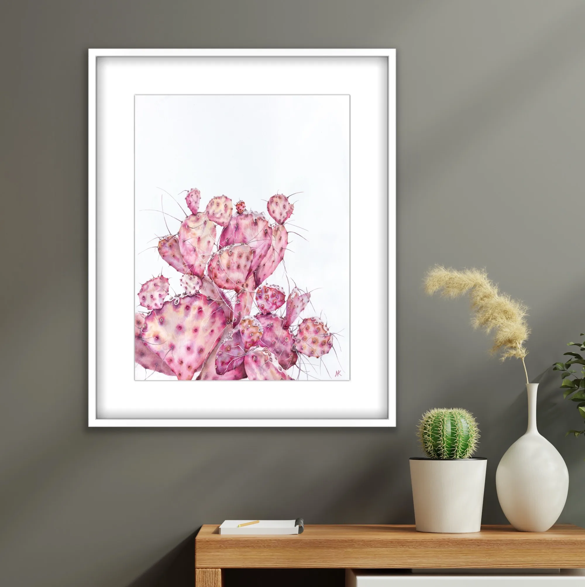 Pink Opuntia cactus watercolor painting framed on a living room wall, blending naturally into a nature-inspired decor, adding a soft and tranquil botanical touch with delicate pastel hues.