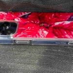 Side view of Red Poinsettia MagSafe iPhone case showing sleek transparent edges, festive floral design combining function and Christmas style.