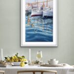 ‘Morning in the Port’ framed in a modern dining room, bringing tranquility with its soft seaside colors.