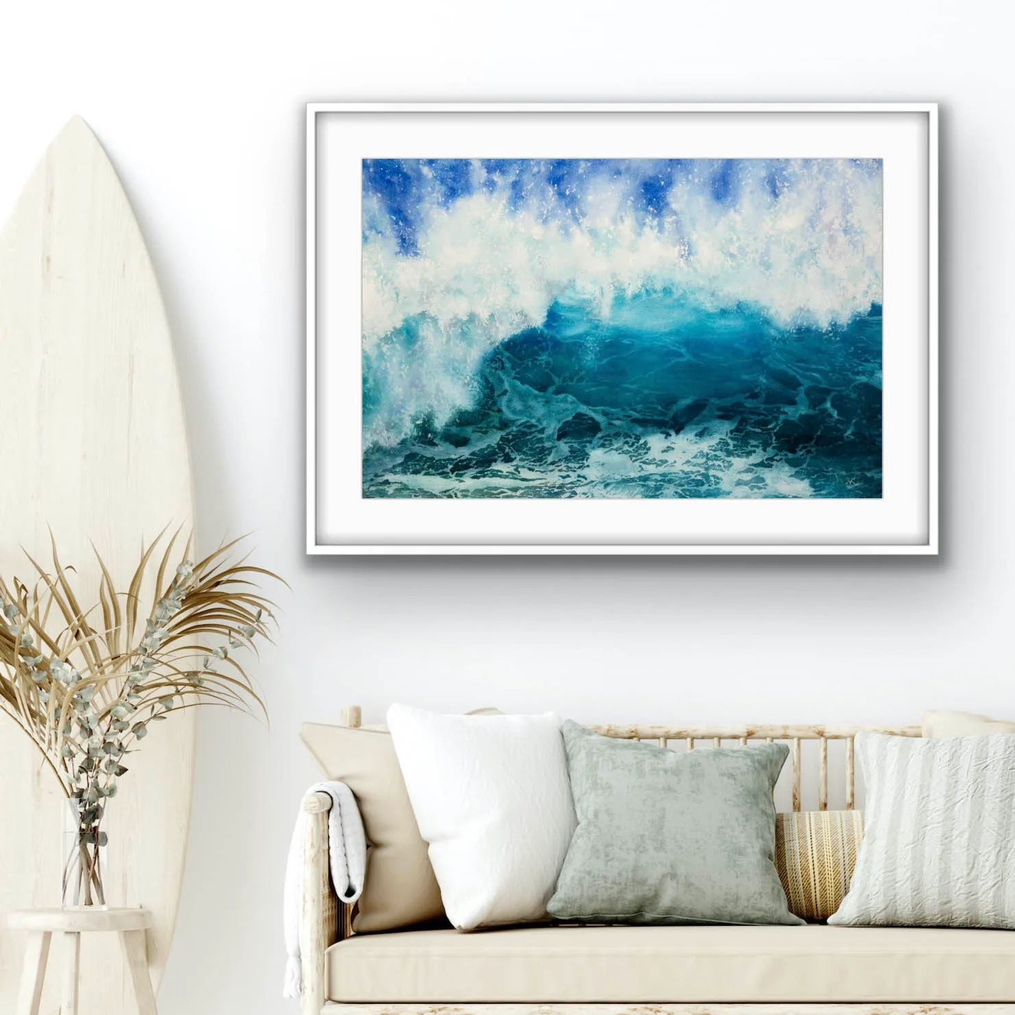 ‘Through the Light’ original watercolor painting above the sofa in a coastal home, depicting dynamic ocean waves with shades of deep blue, turquoise, and sunlight foam, enhancing the serene coastal atmosphere and adding a sense of movement and tranquility to the room.