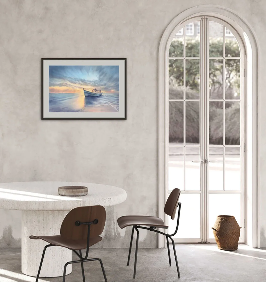 Framed "Morning Solitude" painting enhancing a bright dining space with calming sunrise hues over the water.