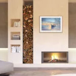 "Morning Solitude" seascape displayed above a fireplace, complementing the cozy and serene atmosphere.