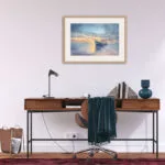 "Morning Solitude" framed seascape above a desk in a home office, inspiring focus and relaxation with its ocean view.