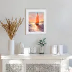 Sailing into the Sunset watercolor painting framed in a coastal-style room, adding warmth and serenity.