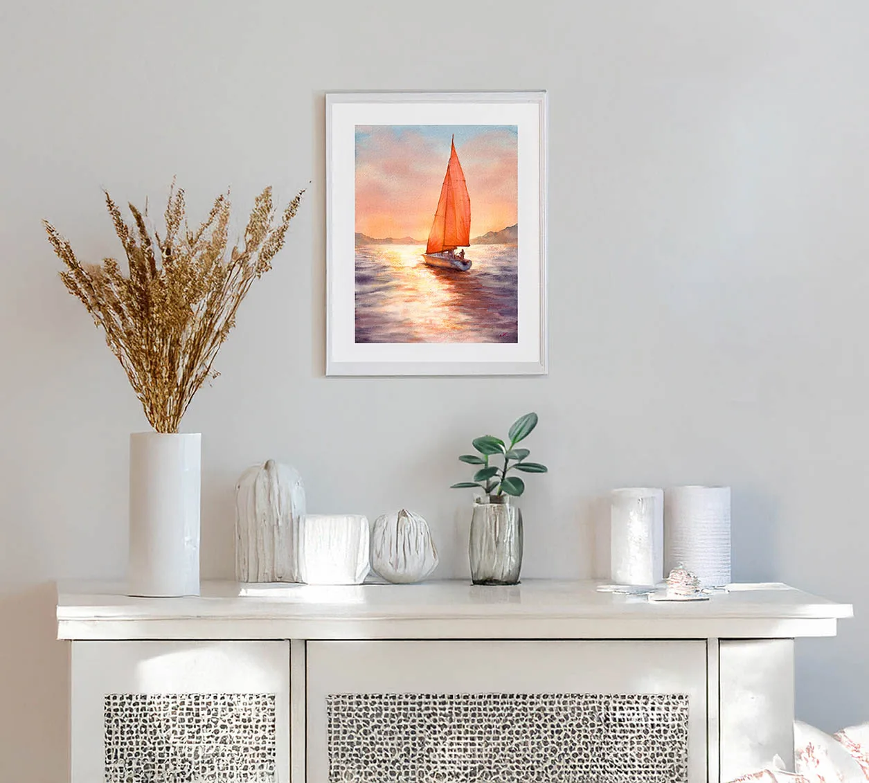 Sailing into the Sunset watercolor painting framed in a coastal-style room, adding warmth and serenity.