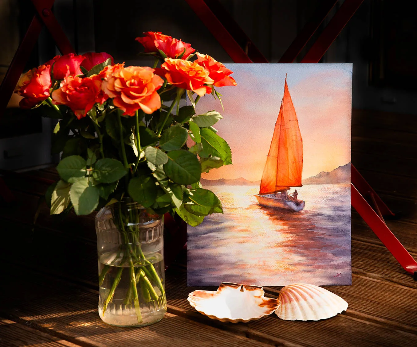 Sailing into the Sunset artwork in an artist’s studio, surrounded by flowers, capturing the warm, dreamy glow of a sunset at sea.