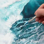Artist's painting process with watercolor brushes and paint on the artwork.
