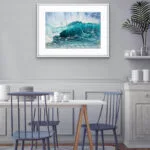 Splash watercolor artwork enhancing the coastal design of a bright dining room.