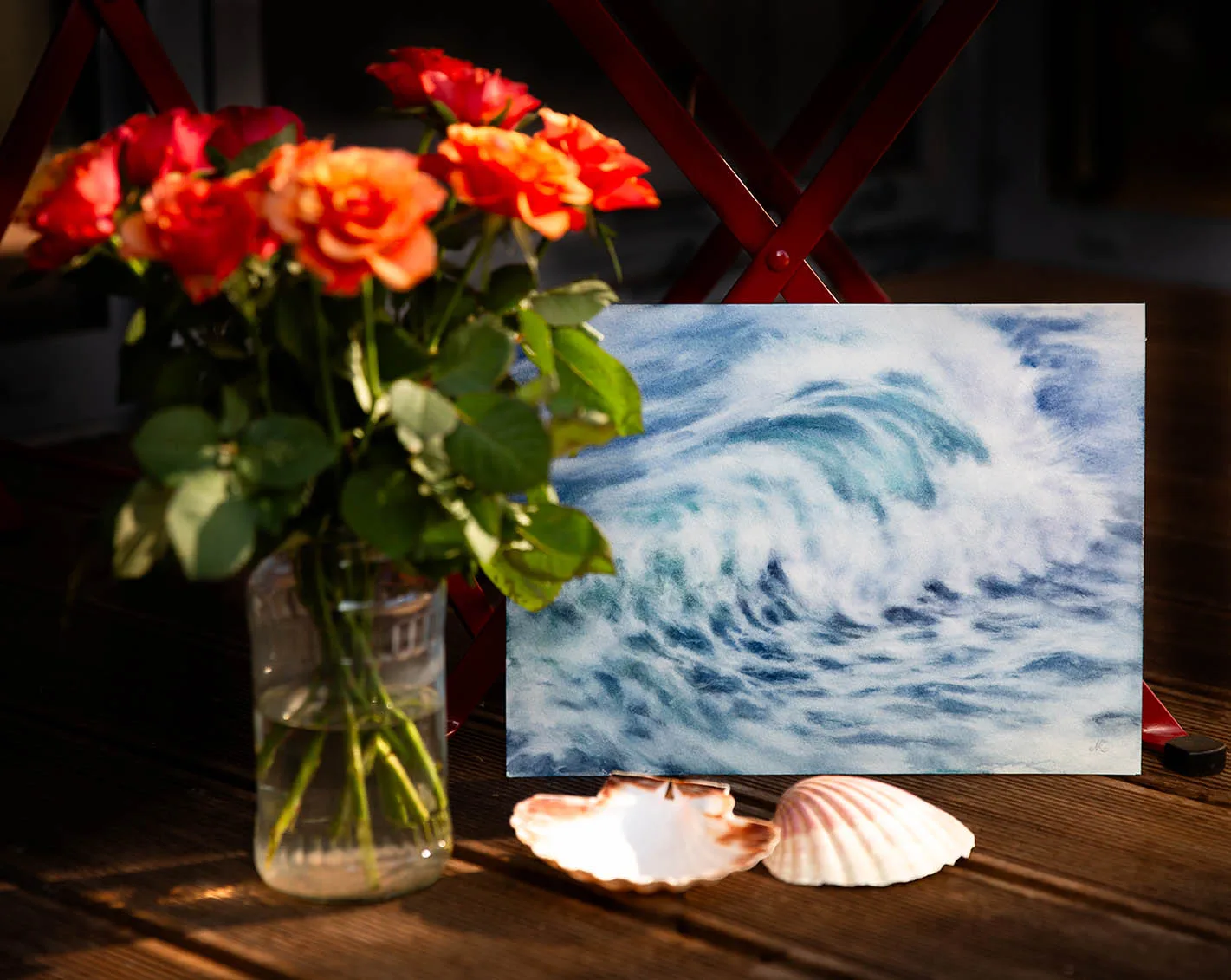 Whispering Wave watercolor painting in a coastal-inspired studio interior, complemented by delicate flowers, evoking a serene and refreshing ocean ambiance.