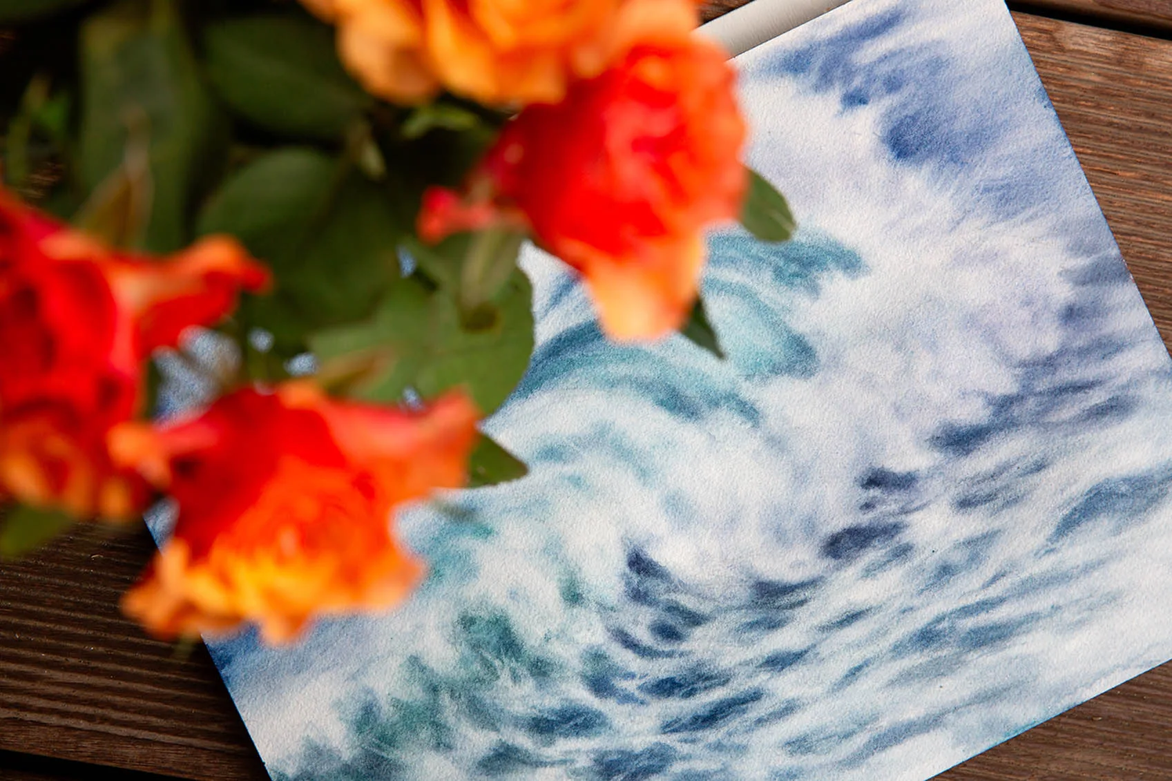Whispering Wave original seascape watercolor displayed in an artist’s studio, capturing the rhythmic motion of the sea with soft blues and misty white foam.