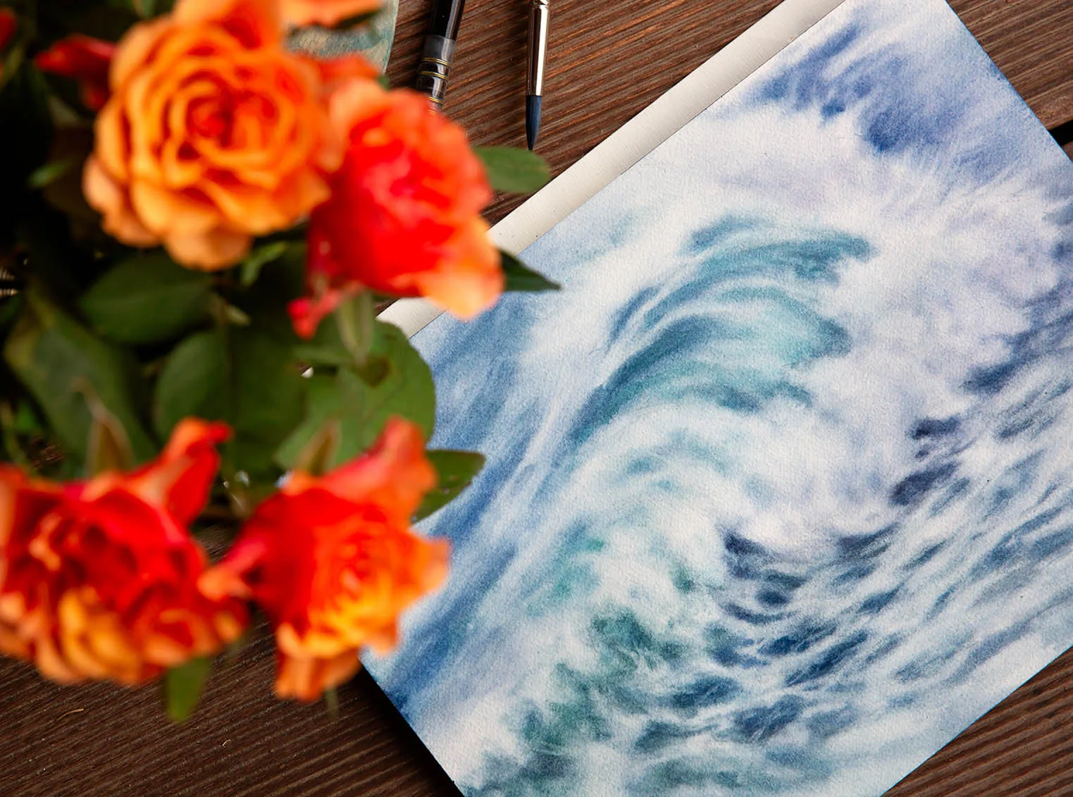 Whispering Wave watercolor painting in progress, showcasing delicate brushstrokes as layers of ocean blues and misty white foam come to life in the artist’s studio.