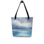 Tote bag featuring a dramatic ocean wave design from the watercolor painting "Where Storm Meets Light" by Kateryna Nazarenko. The artwork captures stormy skies and serene ocean reflections in shades of blue, gray, and white. Perfect for beach trips, shopping, and daily use.