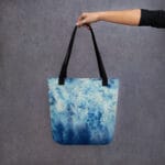 Blue Ocean Tote Bag being in hand, showcasing its abstract seascape print – perfect reusable beach bag, ocean gift idea, or artistic tote for nature and watercolor lovers.