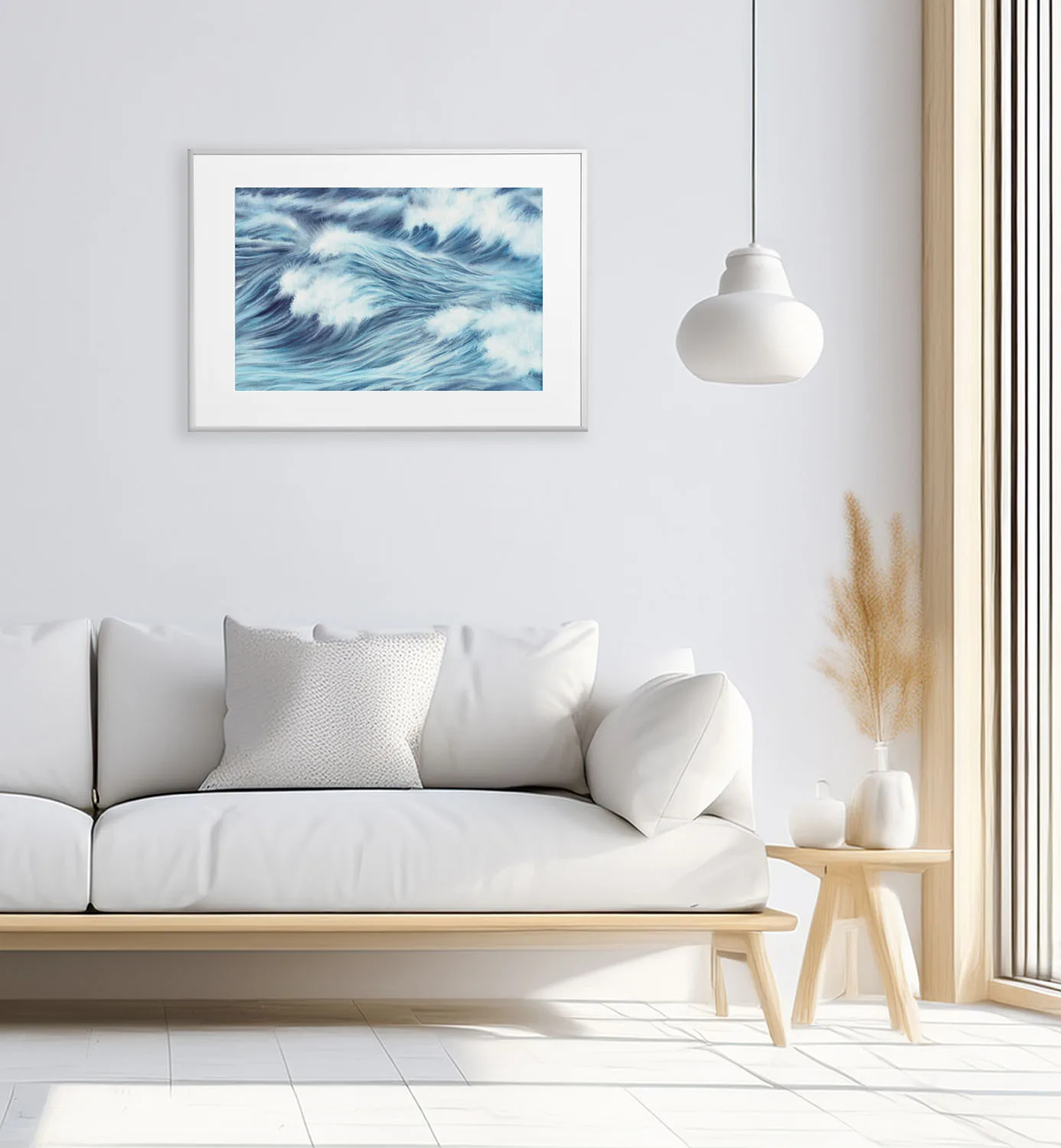 White and airy living room with framed ocean art print, Blue Ocean Whisper watercolor adds marine tranquility and modern coastal aesthetic.