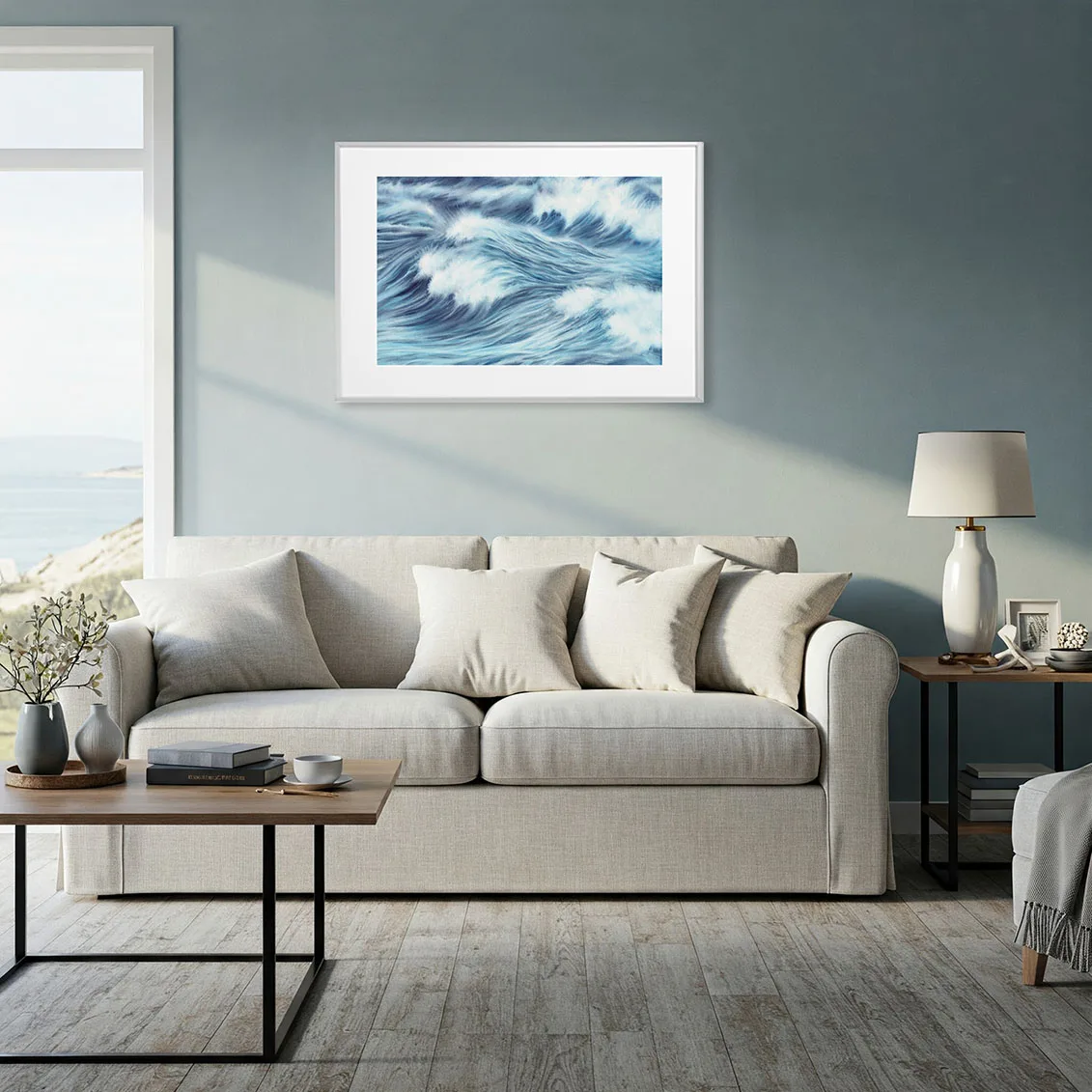 Large sofa in beach house living room with Blue Ocean Whisper fine art print, elegant abstract seascape enhancing relaxing ocean theme.