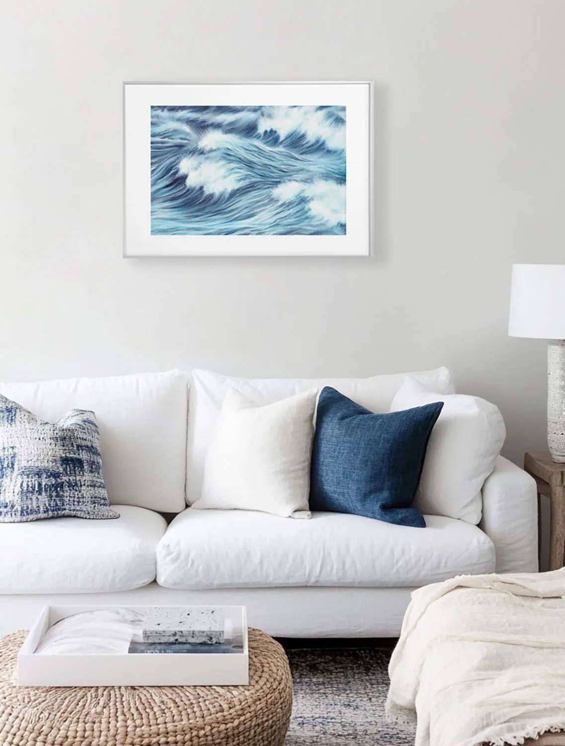 Sunlit coastal living room with framed seascape print Blue Ocean Whisper, soft ocean tones in blue and white for ocean lovers’ interiors.