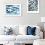 Ocean-themed living room with Blue Ocean Whisper wall art, blue abstract wave print bringing freshness and beach calm to home.