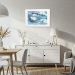 Coastal dining room with framed Blue Ocean Whisper fine art print, ocean wave watercolor painting perfect for serene seaside-inspired meals.