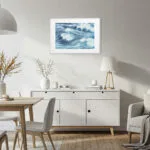 Coastal dining room with framed Blue Ocean Whisper fine art print, ocean wave watercolor painting perfect for serene seaside-inspired meals.