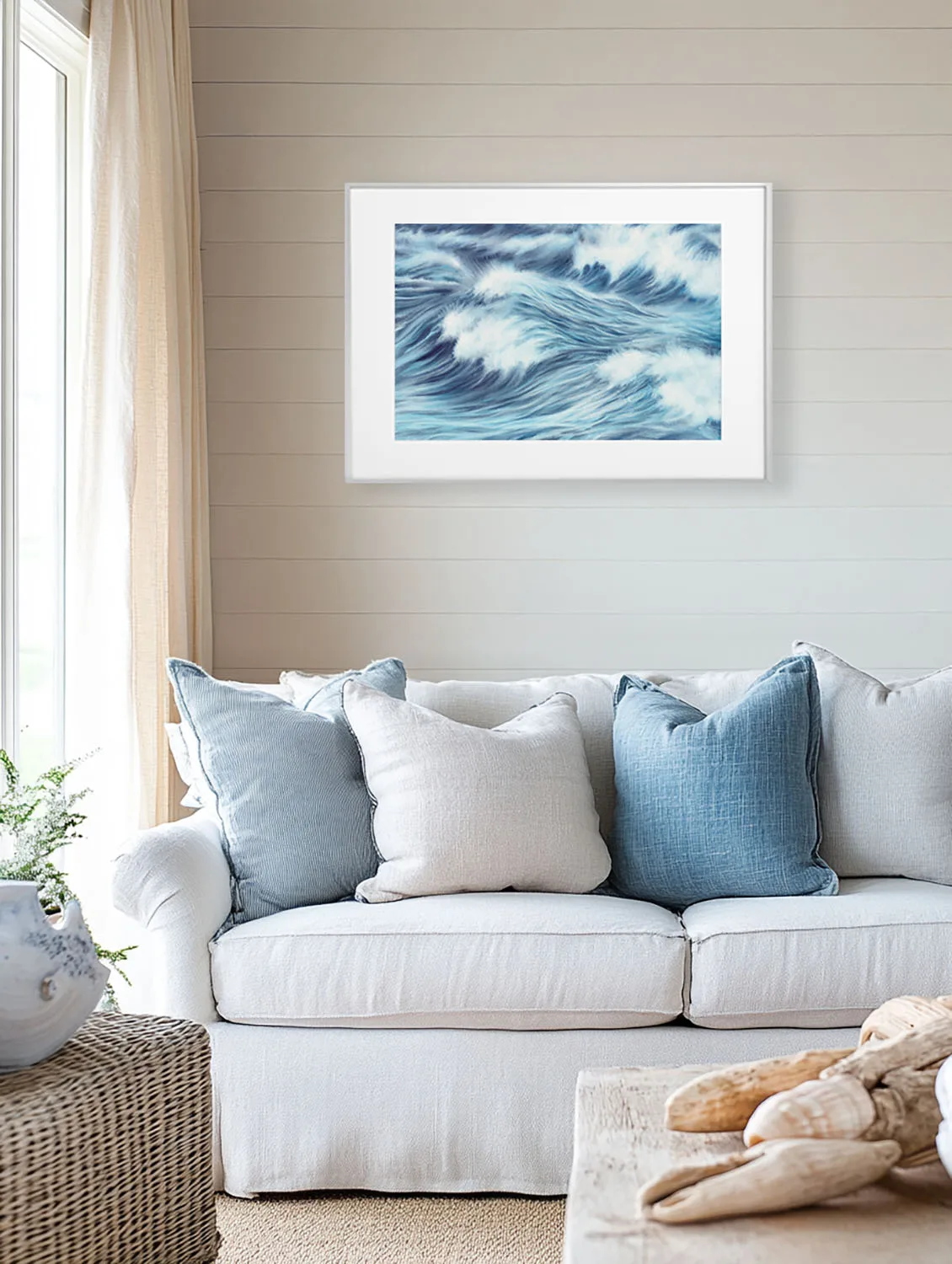 Living room with ocean-inspired print "Blue Ocean Whisper," abstract waves in soft blue, modern sea wall art for beach house interiors.