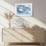 Ocean-inspired living room with framed Blue Ocean Whisper print, seascape wall art enhancing calm, coastal home ambiance.