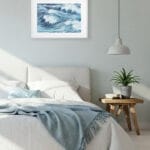 Minimalist bedroom with Blue Ocean Whisper watercolor ocean artwork, fine art print in soft blue tones ideal for tranquil sleep space.