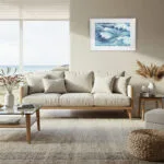 Boho coastal living room with Blue Ocean Whisper artwork, ocean wave watercolor print complements natural textures and soft seaside colors.