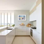 Watercolor sunrise seascape print Morning Solitude bringing peaceful coastal vibes into a kitchen with nature-inspired wall art and ocean decor.