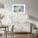 Tranquil watercolor painting print Morning Solitude with boat and ocean at dawn, enhancing a coastal living room with calming sea tones and beach house style.
