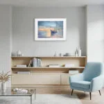 Contemporary living room decor with framed Morning Solitude watercolor print, a tranquil ocean sunrise scene with soft colors and gentle coastal tones.