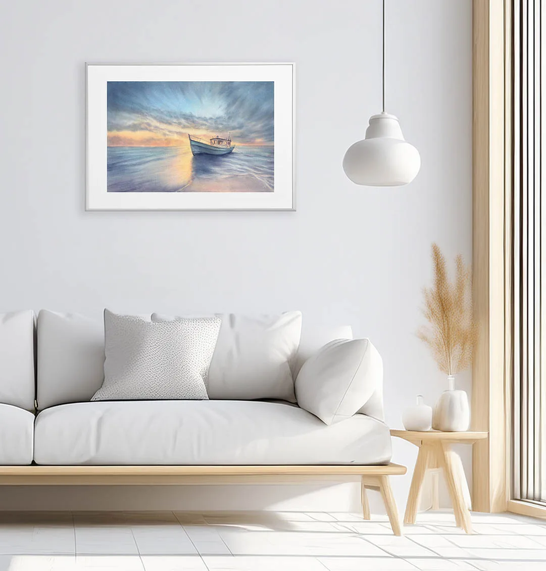 Elegant modern white living room with framed fine art print Morning Solitude, a peaceful watercolor seascape featuring sunrise, calm water, and a resting boat.