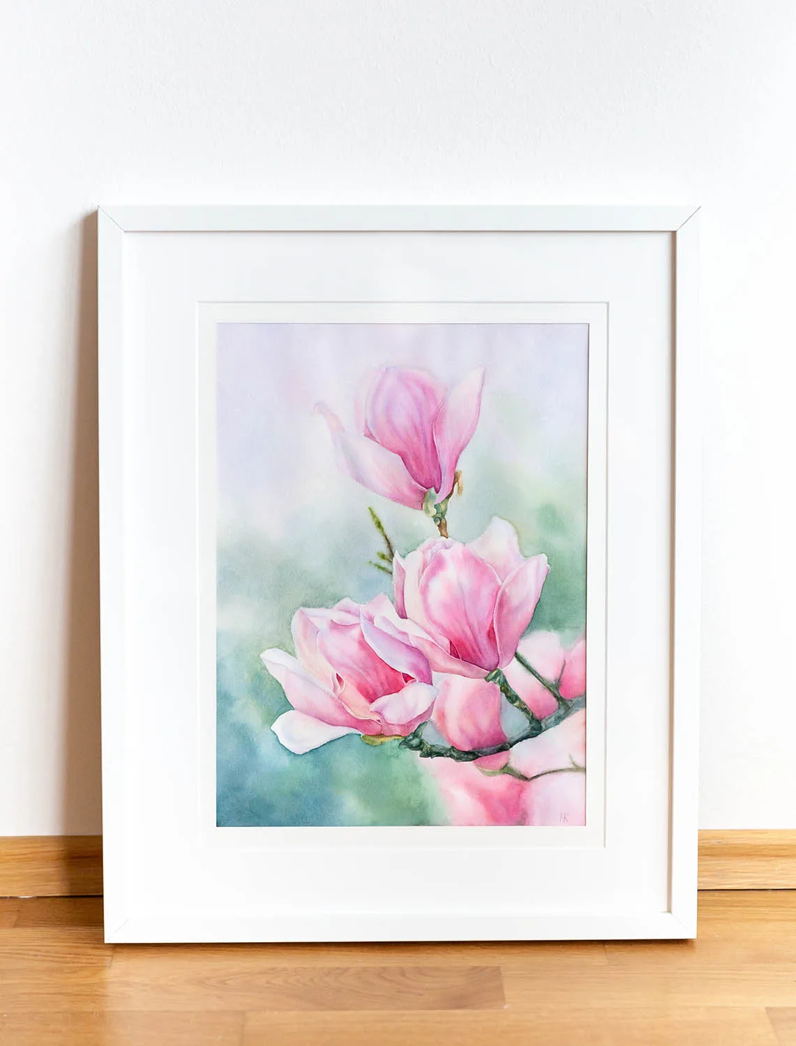 Pink Magnolias watercolor painting beautifully framed, enhancing the delicate charm of magnolia blossoms.