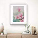 Pink Magnolias framed and displayed in a cozy living room, creating a serene and elegant atmosphere.