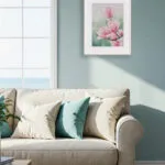 Soft pink magnolia blossoms in Pink Magnolias watercolor painting, enhancing a cozy living space above sofa with nature-inspired beauty.
