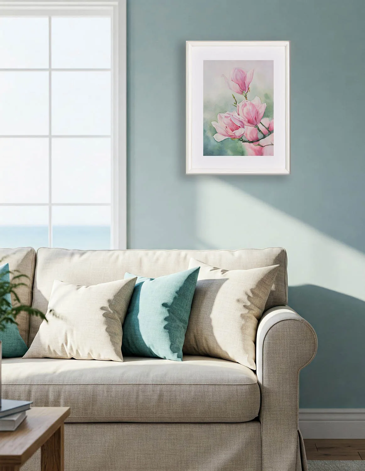 Soft pink magnolia blossoms in Pink Magnolias watercolor painting, enhancing a cozy living space above sofa with nature-inspired beauty.