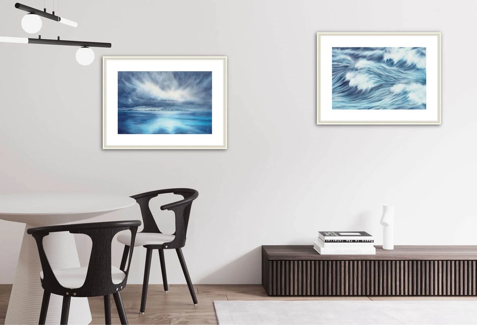 "Where Storm Meets Light" fine art print of a stormy sea watercolor painting displayed in a living room dining area. This blue ocean wall art serves as a captivating focal point, enhancing the open, airy space with its dramatic seascape and coastal-inspired decor.