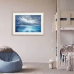 "Where Storm Meets Light" fine art print of a stormy sea watercolor painting displayed in a kids' bedroom. This blue ocean wall art inspires imagination and wonder, offering a soft and soothing seascape to enhance the playful, coastal-themed room decor.