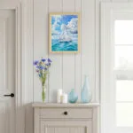 Sailboat watercolor wall art in coastal living room with natural light, peaceful sea painting for home interiors