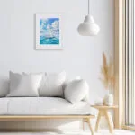 Blue Voyage sailboat watercolor painting above sofa in bright coastal living room, nautical wall art for ocean lovers