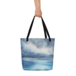 Stormy sky and blue ocean watercolor art printed on a large beach tote bag