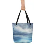 Stormy sky and blue ocean watercolor art printed on a large beach tote bag