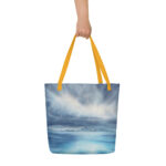 Beach tote bag with tranquil blue ocean, clouds, and serene light reflection