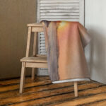 Ocean sunset beach towel with soft golden tones