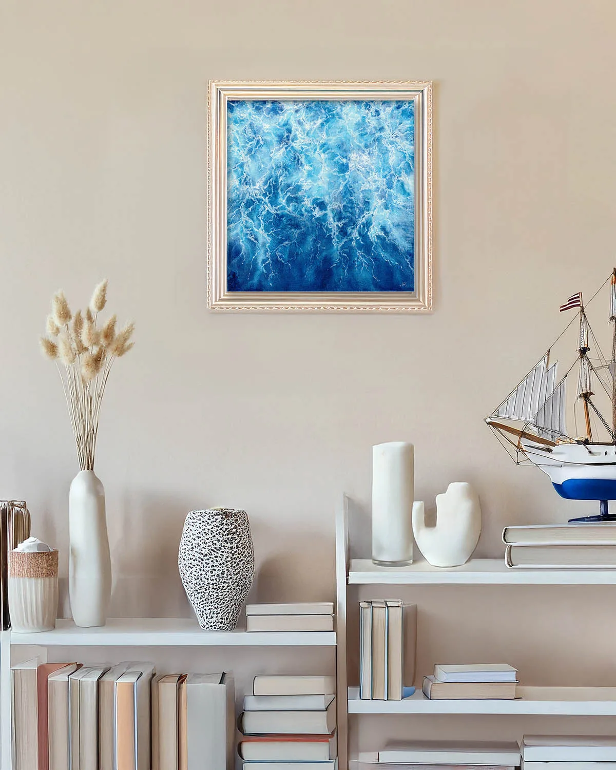 Framed abstract ocean painting "Liquid Energy" displayed in modern interior, blue watercolor artwork adding a coastal and contemporary feel to the space.