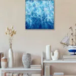 "Liquid Energy" abstract watercolor of ocean waves placed in coastal living room decor, bringing marine color palette and sea-inspired motion to the interior.